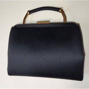 Premiere Editions black clutch purse with small handle, snap top closure